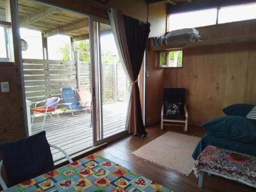 a living room with a sliding glass door to a deck at La Casita del Puente in La Pedrera