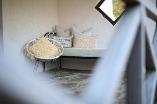 a bed with pillows and a table in a room at Dennehof Karoo Guesthouse in Prince Albert