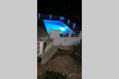 an aerial view of a house at night with a swimming pool at Villa Célia Alzira in Alzira