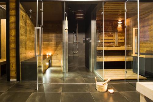 a shower with a glass door in a bathroom at Apartmány a Wellness VMAL s.r.o. in Skuteč