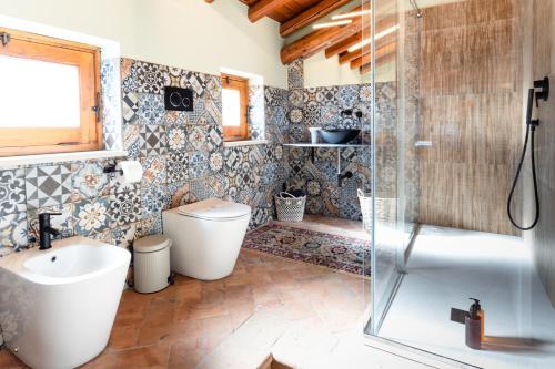 a bathroom with a shower and a toilet and a sink at Raciti Palace in Acireale