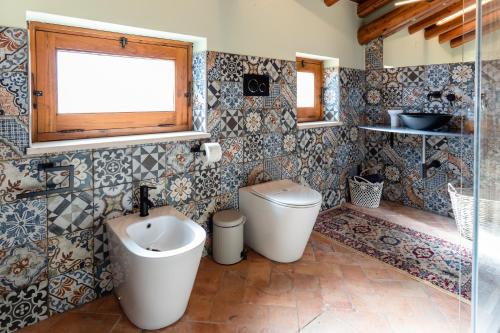a bathroom with a toilet and a sink at Raciti Palace in Acireale