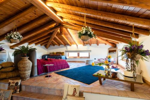 a living room with wooden ceilings and a blue rug at Raciti Palace in Acireale