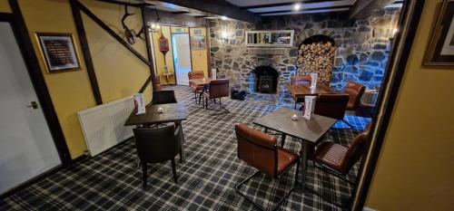 an overhead view of a restaurant with chairs and a fireplace at The Inn At Lathones in St. Andrews