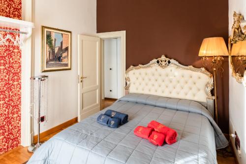 a bed with two blue and red pillows on it at Raciti Palace in Acireale