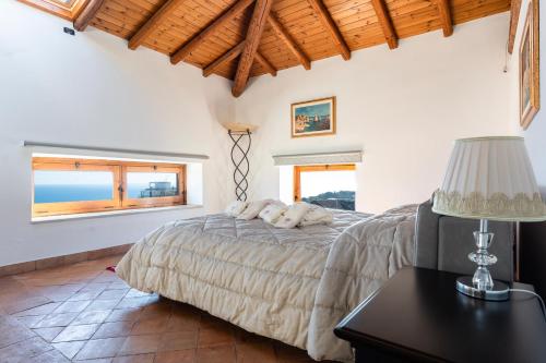 a bedroom with a bed and a table with a lamp at Raciti Palace in Acireale