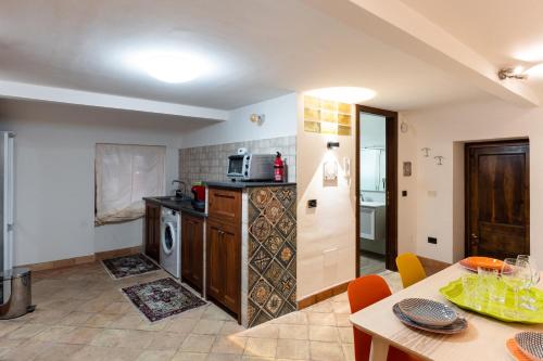 a kitchen and dining room with a table and a kitchen at Raciti Palace in Acireale