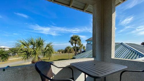 a table and chairs on a porch with a window at JEKYLL KEEPERS QUARTERS apts in Jekyll Island