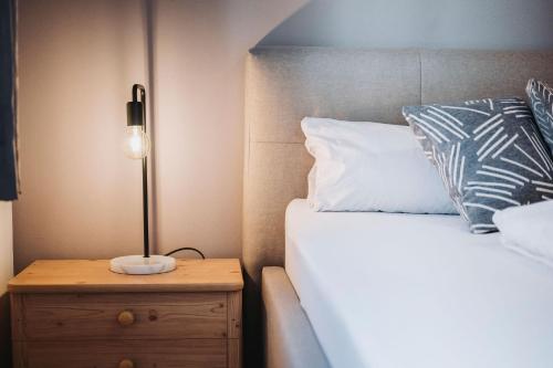 a bedroom with a bed and a lamp on a night stand at Appartement Stern Dagmar in Neustift im Stubaital