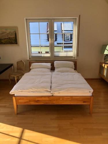 a large bed in a room with a window at Superschöne Ferienwohnungen! in Buxheim