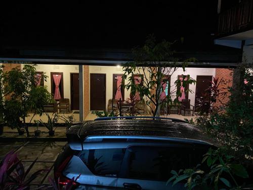 a car parked in front of a house at night at Watukarung Sackstone Guesthouse in Kalak