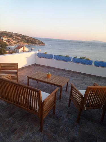 a patio with benches and a view of the ocean at The View Stara Baška in Stara Baška
