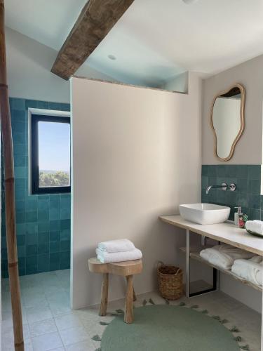 une salle de bain avec un lavabo et un miroir dans l'établissement Le Mas Angelou, à Maussane-les-Alpilles
