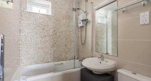 a bathroom with a sink and a shower and a sink at Osprey 2 - The Cove in Brixham