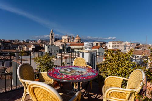 a table and chairs on a balcony with a view at Raciti Palace in Acireale