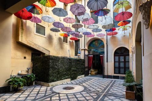 a bunch of umbrellas hanging from a building at Raciti Palace in Acireale