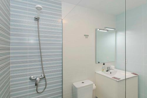 a bathroom with a shower and a toilet and a sink at Sur Restinga in La Restinga