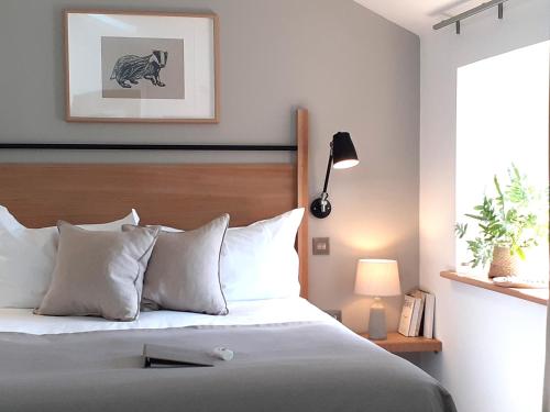 a bedroom with a bed with a wooden headboard at Lancaster Barn in Lancaster
