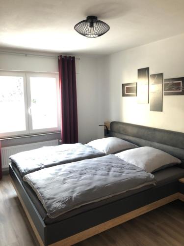 a bedroom with two beds and a window at Ferienwohnung Dunja in Bullay