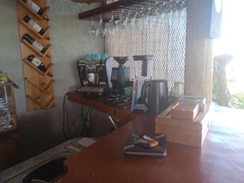 a kitchen with a table with a coffee maker at Arena Oceanview Hotel & La Terraza Restaurant in Las Galeras
