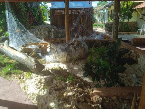 a hammock in the yard of a house at Arena Oceanview Hotel & La Terraza Restaurant in Las Galeras