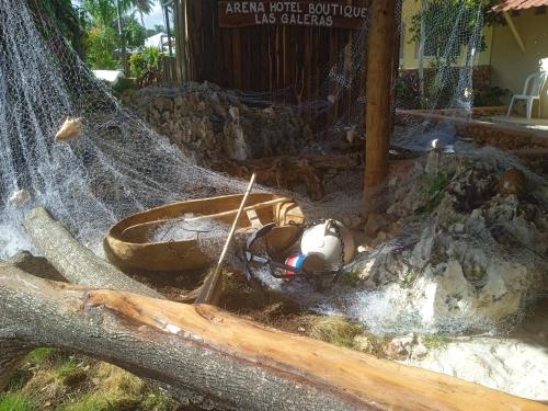 a person laying on the ground in a hammock at Arena Oceanview Hotel & La Terraza Restaurant in Las Galeras