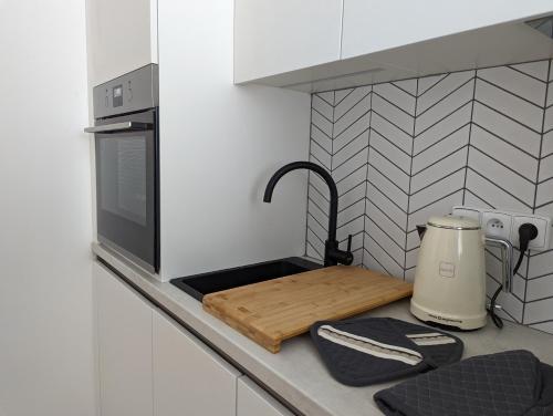 a kitchen counter with a sink and a microwave at JASMIN HOME Apartments in Vítkovice