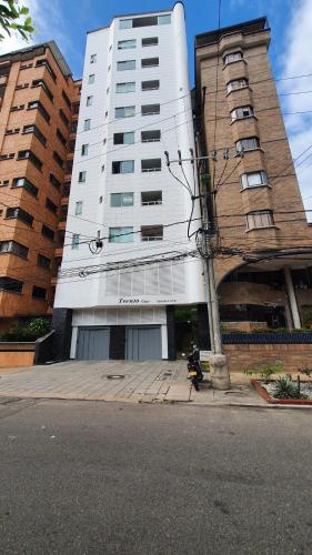 a motorcycle parked in front of a tall building at Apto Botero 704 - WAIWA HOST in Bucaramanga
