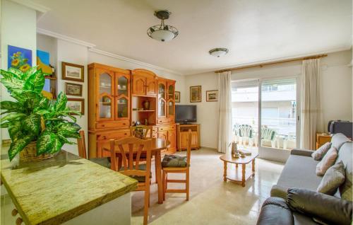 a living room with a couch and a table at Beautiful Apartment In Santa Pola in Santa Pola