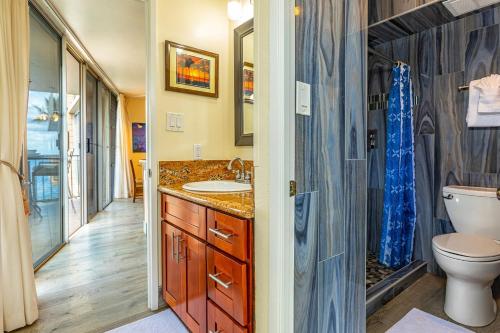 a bathroom with a sink and a toilet at Kamaole Nalu 402 condo in Kihei