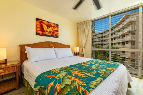 a bedroom with a bed and a large window at Kamaole Nalu 402 condo in Kihei