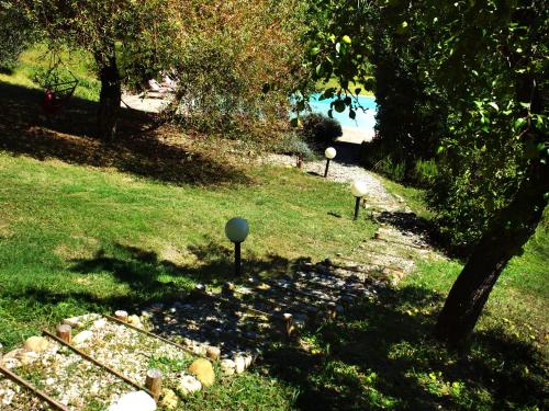 a garden with three small lights in the grass at Polvereto in Le Fornacette