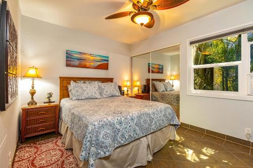 a bedroom with a bed and a ceiling fan at Kihei Garden Estates D104 condo in Kihei