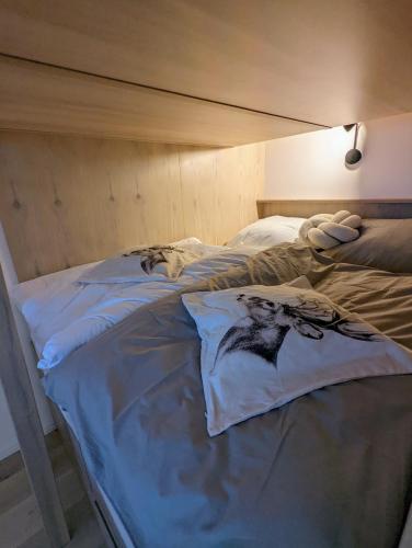 a bed with two pillows on top of it at JASMIN HOME Apartments in Vítkovice