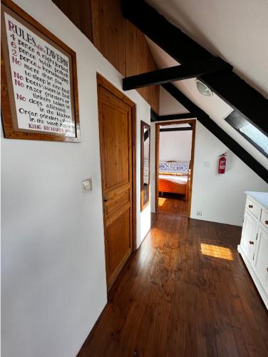 an attic room with a door and a bedroom at Maison de Maison in Maël-Pestivien