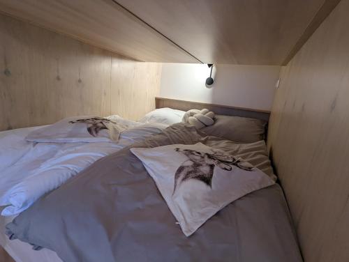 a bed with a teddy bear on it in a room at JASMIN HOME Apartments in Vítkovice