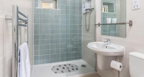 a bathroom with a sink and a toilet and a shower at Sandpiper 3 - The Cove - Stunning views, Heated Pool, Allocated Parking in Brixham