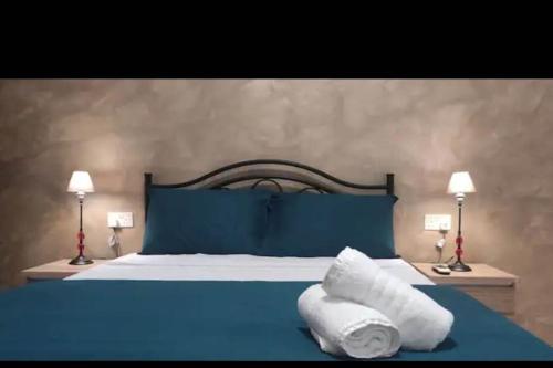 a blue bed with towels laying on top of it at Valletta Apartment with Harbour Veiw in Valletta