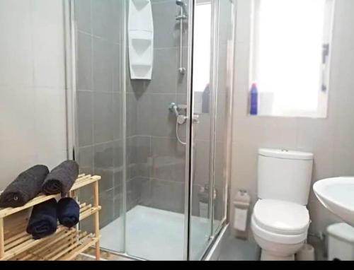 a bathroom with a shower and a toilet and a sink at Valletta Apartment with Harbour Veiw in Valletta