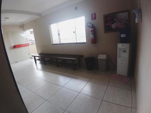 a living room with a bench and a window at Hotel Jerusalém 2 in Goiânia