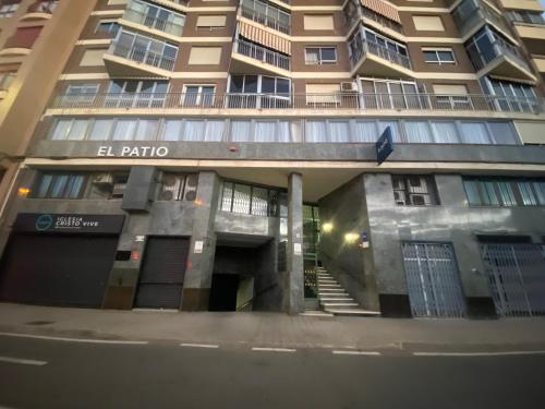 a building with a stairway leading up to a building at El Patio Hostal in Alicante