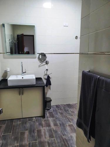 a bathroom with a sink and a mirror at CASA LOKO Guest House in Luxor