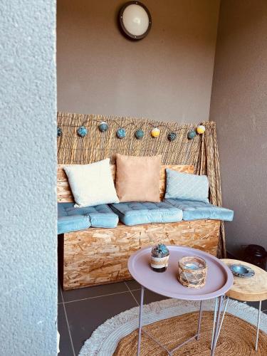 a couch with pillows and a table in a room at SUPERBE STUDIO AVEC PLACE DE PARKING in Ajaccio