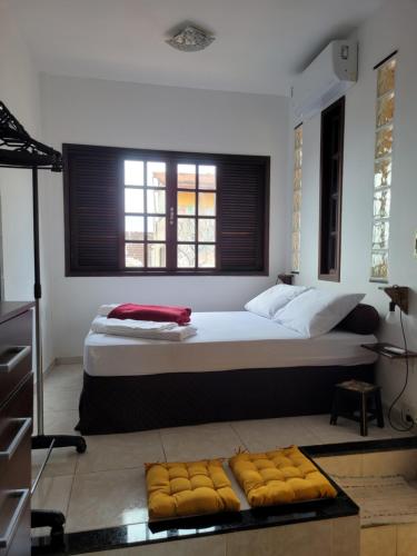 a bedroom with a large bed with a window at Santo Mirante Hostel in Rio de Janeiro