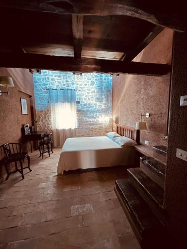 a bedroom with a bed and a brick wall at Agriturismo Casale Montebello in Monteleone di Spoleto