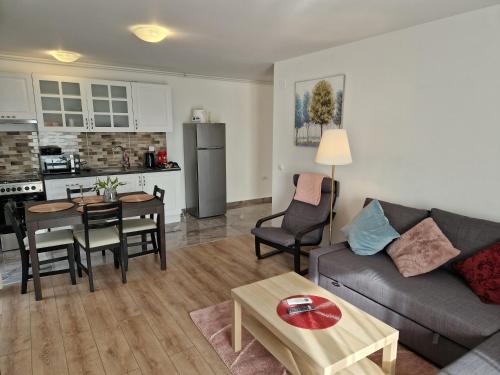 a living room with a couch and a table at Star Airport Residence in Otopeni