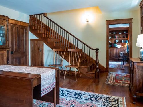 a living room with a wooden staircase in a house at Wren Retweet in Chestertown