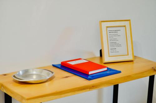 a table with a bowl and a plate and a book at Apartamento da vila by Morna Homes in Vila Baleira