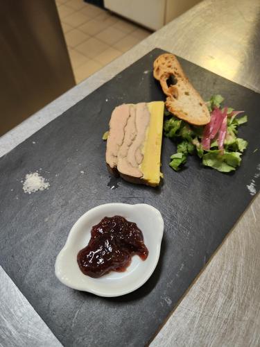 a plate of food with meat and cheese and salad at hotel du Nord in Brassy