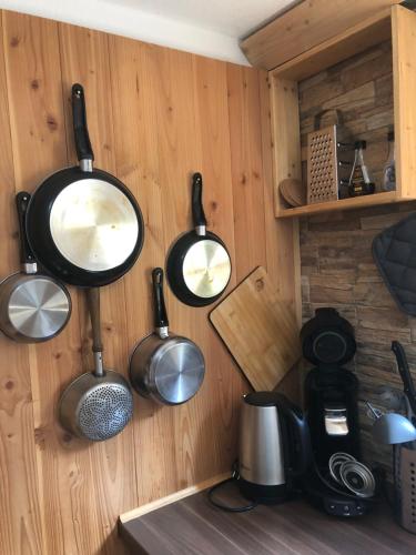 a kitchen with pots and pans hanging on a wall at Im kleinen Paradies in Schopfheim